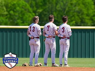 From left, Liberty-Eylau's Britain Pipes, W.T. Jones and Tirston Haugh line up for the National Anthem before their game against Pleasant Grove on Friday, April 12, 2023, at H.E. Markham Park in Texarkana, Texas. (Photo courtesy of Texarkana Gameday)